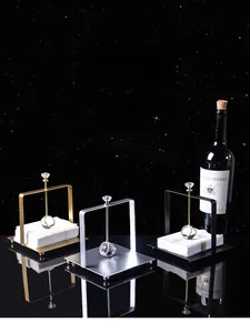 Close-up of Nordic square napkin holders in gold, silver and black with crystal gravity bars
