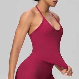 Detail view of high-elasticity halter sports bra and leggings set in dark burgundy color