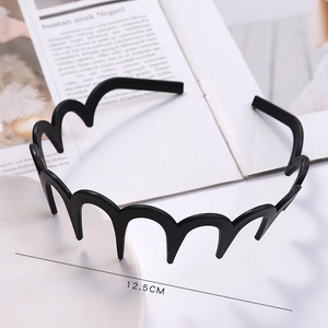 Detail shot of wavy black headband in a tray showing 12.5CM diameter measurement