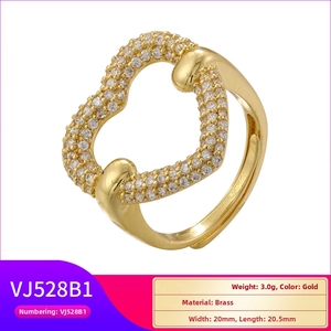 Detailed view of adjustable golden heart-shaped brass ring with clear cubic zirconia stones