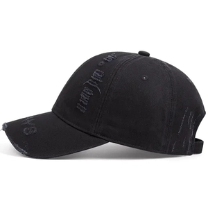 Retro distressed black cotton baseball cap with ripped details and embroidery on white background