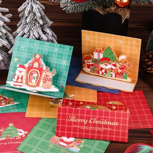 3D pop-up Christmas greeting card set with envelopes on a festive wooden surface