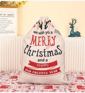 Detail of canvas Christmas drawstring gift bag with festive typography and reindeer print