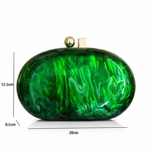 Detail showing marble-textured green acrylic evening bag with dimension markings