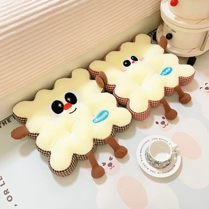 Cute biscuit-shaped plush chair cushions with cartoon faces and plaid details in cozy room