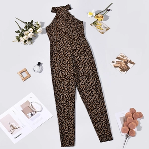 Flat lay of leopard print sleeveless jumpsuit with elegant white roses and accessories