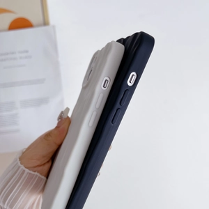 Close-up of side buttons and precise cutouts on black and white crinkle silicone cases