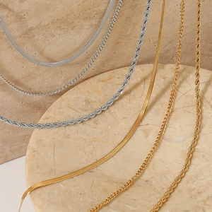 Minimalist layered stainless steel snake and curb chains in gold and silver finishes