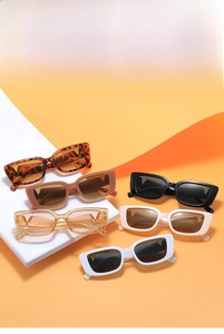 Detailed close-up of six rectangular sunglasses with metallic V-shaped temple accents