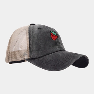 Close-up of strawberry embroidery on retro distressed grey mesh baseball cap