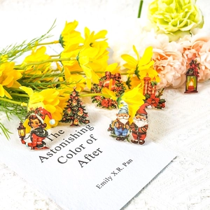 Macro detail of retro Christmas PET stickers with Santa and floral accents on a desk