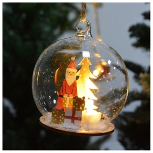 Macro view of a Christmas glass ball with a Santa Claus figurine and warm LED lighting