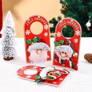 Detail of Christmas felt door hangers with Santa, Snowman and Reindeer on table