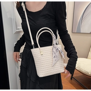 Detail of white woven texture handbag with floral silk scarf and detachable shoulder strap