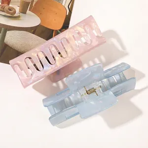 Pink and blue large PVC hair claws with pearlescent marble texture in a two-piece set