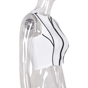 Close-up of white ribbed tank top featuring black contrast trim and a front zipper closure