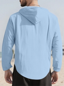 Outdoor back view of men's light blue hooded cotton shirt with curved hem details