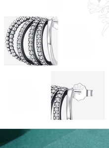 Macro detail of S925 sterling silver stamp and multilayer zircon pavé earrings