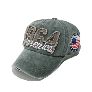 Detailed close-up of 1964 America embroidery on vintage washed denim baseball cap