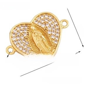 Macro detail of gold plated heart connector with Virgin Mary relief and white zircons