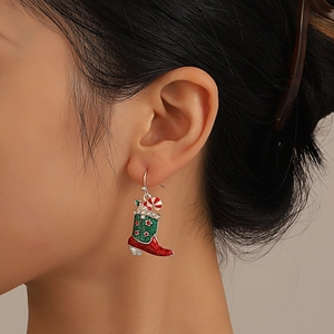 Detailed macro view of a Christmas boot earring with red enamel and sparkling rhinestones