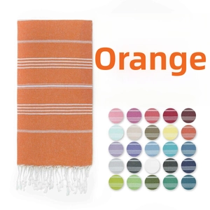 Close-up of orange striped cotton Turkish towel with fringes and multicolor options