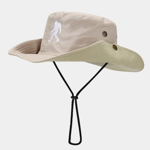 Close-up of khaki outdoor sun hat featuring white bigfoot embroidery and metal eyelets