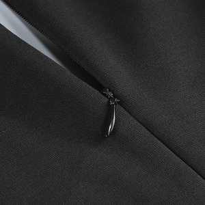 Close-up of a high-quality metal zipper detail on a black cocktail party dress