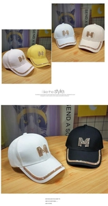 Detail of colorful rhinestone M logo on casual cotton baseball caps in multiple colors
