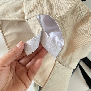 Close-up of adjustable Velcro strap on khaki sun hat for a custom fit and outdoor wear