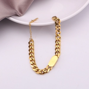 Gold Cuban link chain bracelet with rectangle tag and adjustable clasp on white background