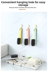 Detail of multi-color long handle shoe brushes hanging for drainage and storage
