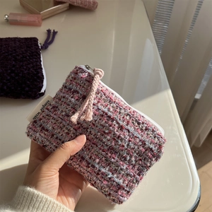 Macro detail of purple tweed mini pouch with zipper and simple wish woven label