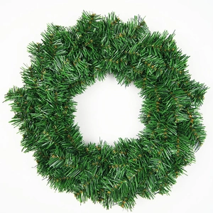 Close-up of the dense green artificial pine needles on a 30cm Christmas wreath