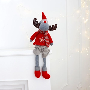 Close-up of a Christmas elk doll with red knit sweater and gray long legs on a white mantel