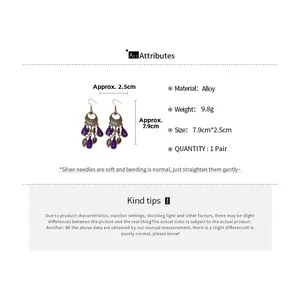 Detail view of Bohemian leaf earrings with bronze alloy and purple beads on white background