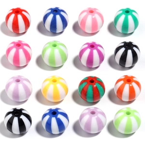 Macro shot of colorful striped acrylic candy beads in a grid layout for DIY jewelry making