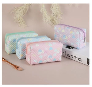 Collection of heart pattern PVC cosmetic bags in pastel purple, pink, blue, and green colors