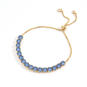 Detailed view of adjustable gold box chain bracelet with brilliant blue round-cut zircon stones