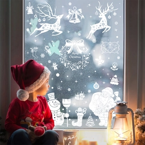 White Christmas window decals featuring reindeer and Santa Claus in a cozy home setting