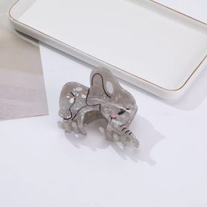 Detail of marble gray acetate elephant hair claw clip with pink accent on white background