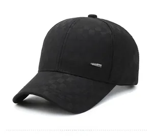 Detail view of black plaid pattern fabric and silver metal logo on baseball cap