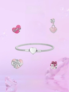 Detailed set of pink heart charms and a snake chain bracelet with silver bow pendants