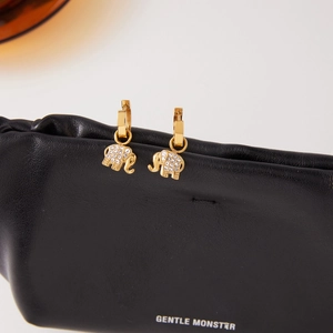 Luxurious 18K gold plated elephant drop earrings with sparkling pavé zircons on black leather