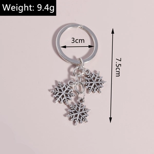 Detail showing antique silver snowflake keychain with 3cm ring and 7.5cm length measurements