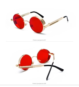 Detail of steampunk round sunglasses with gold metal frame and red lenses with spring temple