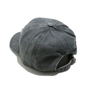 Detail of washed cotton baseball cap showing adjustable strap and vintage twill texture