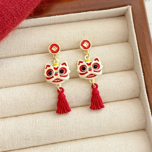 Traditional Chinese lion dance earrings with red tassels in a premium jewelry box