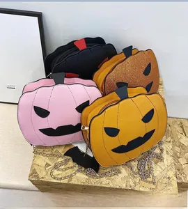 Detailed view of pumpkin-shaped crossbody bags in pink, yellow, black and glitter orange