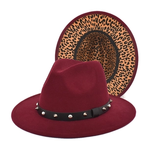 Detail of burgundy wide brim fedora hat with studded band and leopard print lining